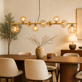 Gouden hanglamp met amber glazen bollen – 9-lichts hanglamp met lange plafondplaat